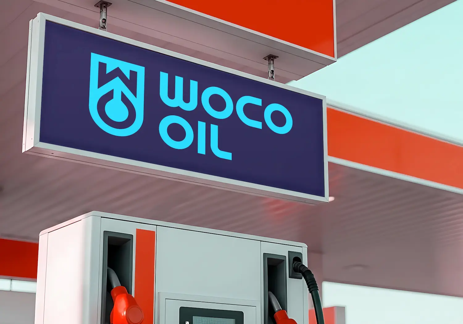 A mockup of the WOCO Oil logo at a gas station