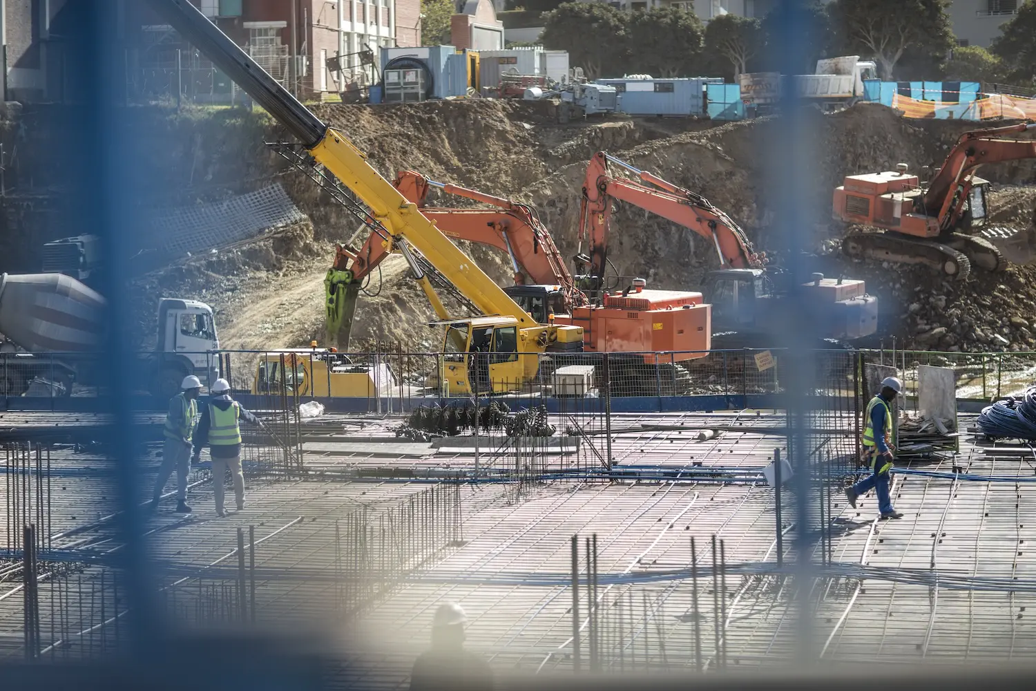 Construction workers laying foundation of building